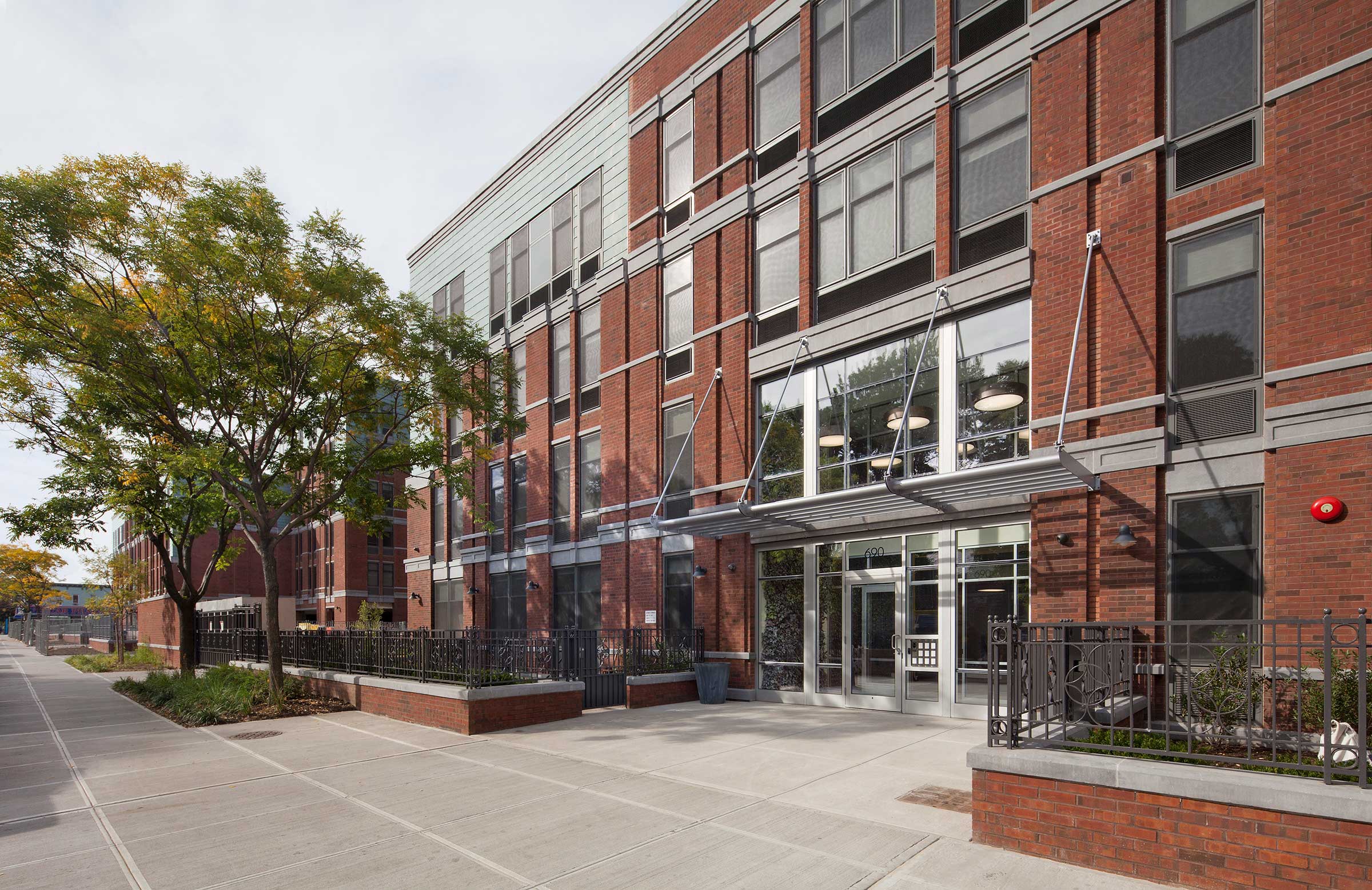 The exterior of a modern brick supportive housing building in Brooklyn, Camba Gardens.