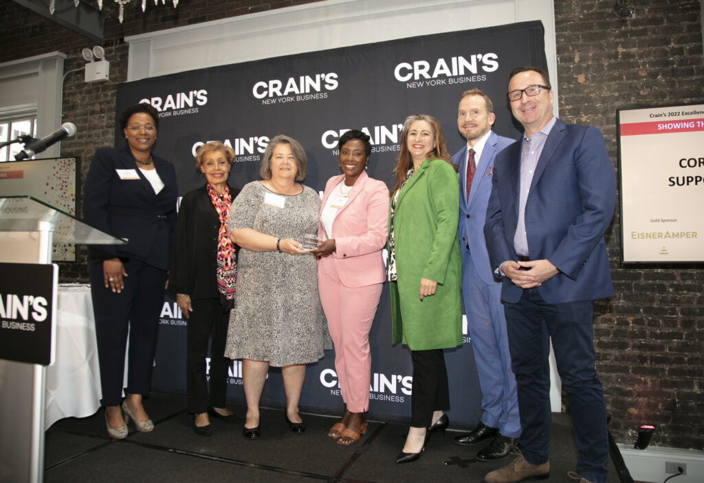 CSH staff accepting Crains New York award posing on the stage