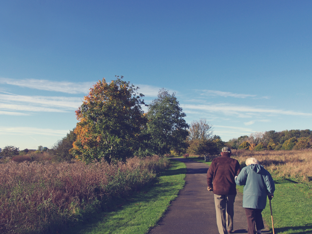 Two Adults Walking Towards Park Retirement