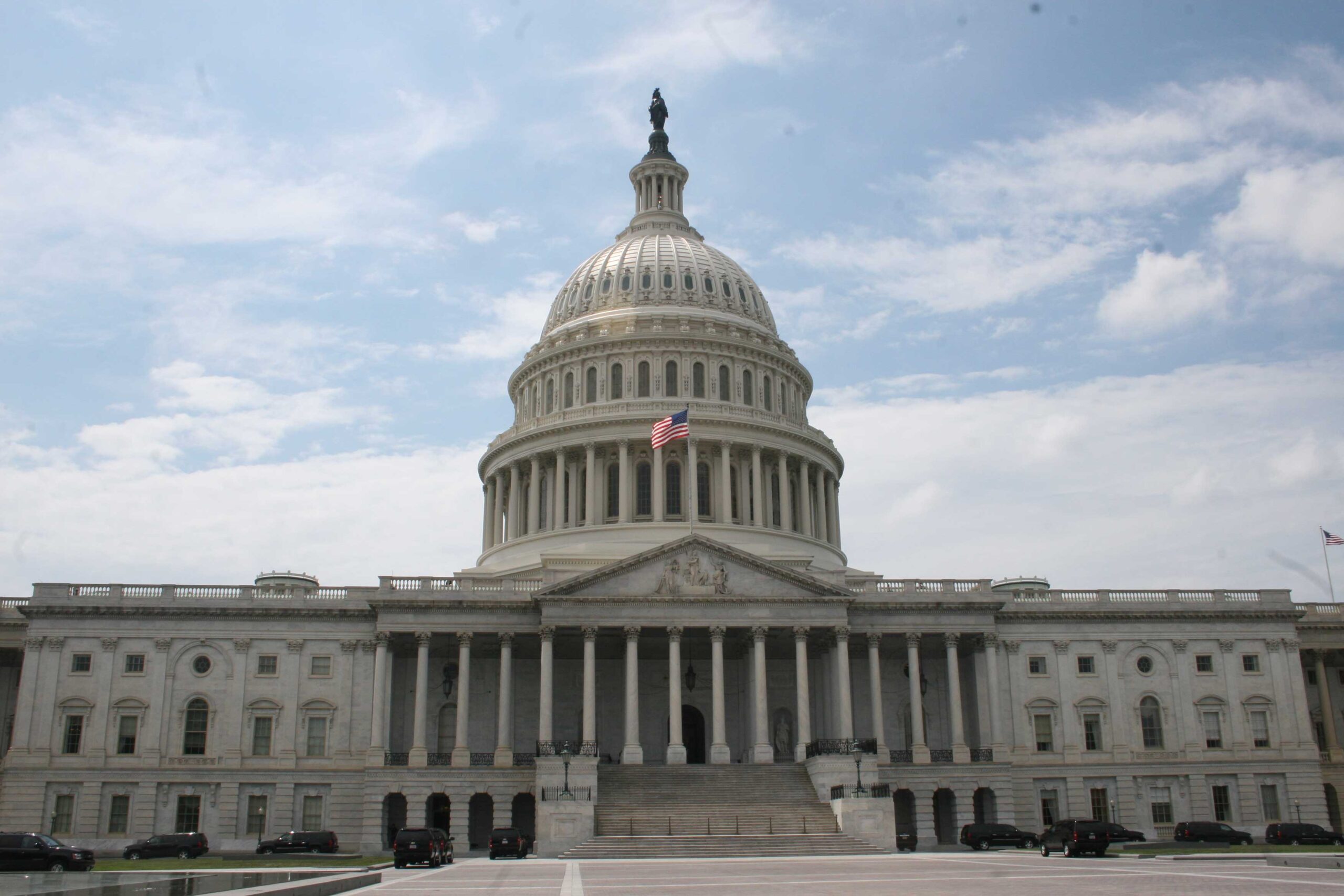 The exterior of the United States Capitol building during the day.