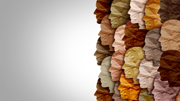 This image represents diversity by showing various skin tones through paper cut-outs faces. 