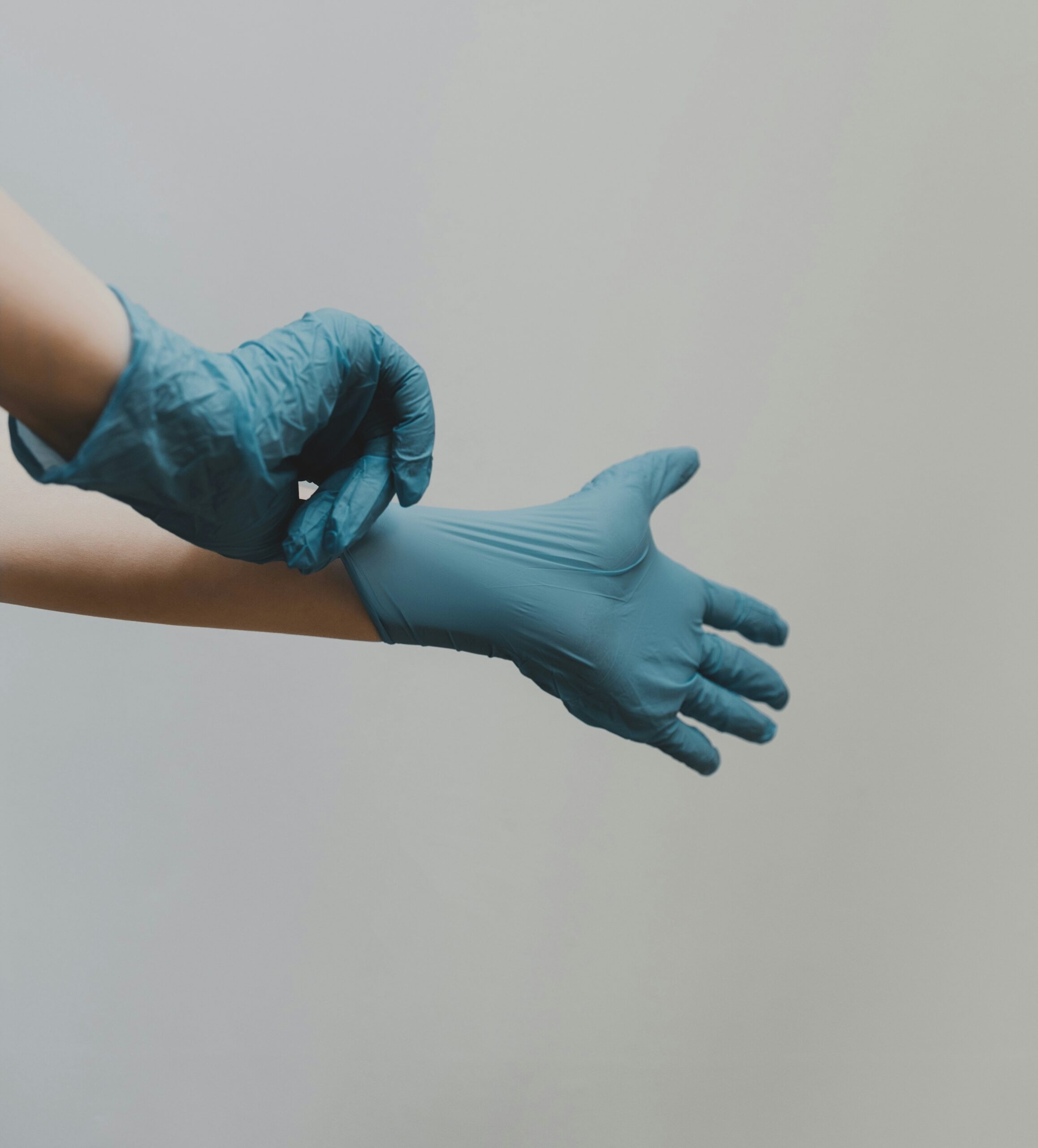 a health worker putting on gloves